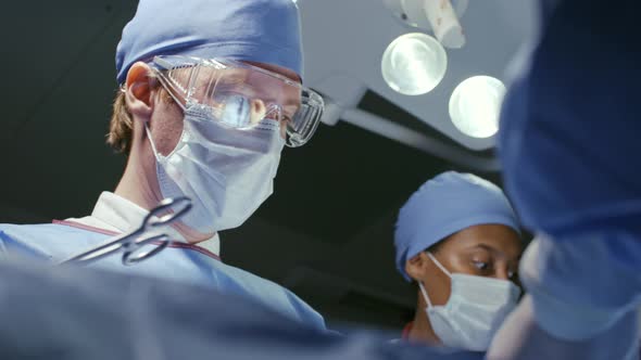 Male Surgeon Working in Operating Room alt