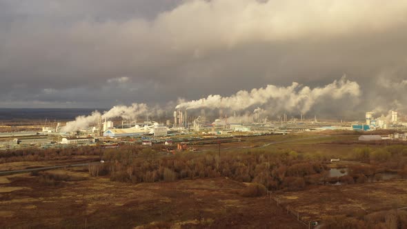 White Smoke Comes Out of a Large Number of Tall Chimneys of Chemical Plants Against the Backdrop of alt