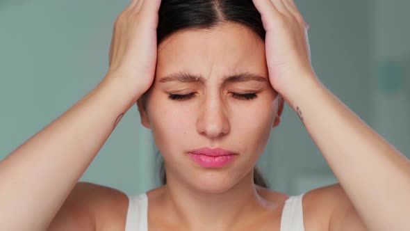 Young Girl Clutches Her Head Showing Headache