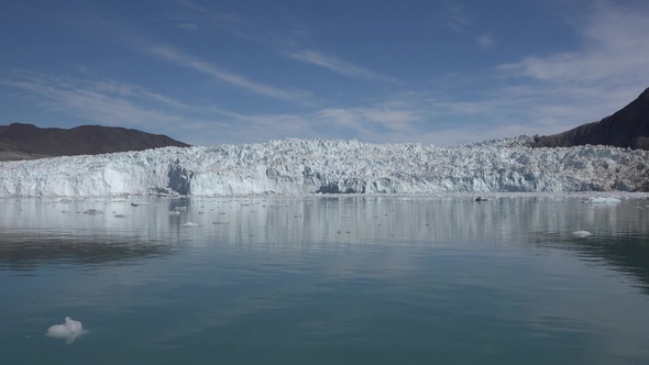 Arctic sailing among glaciers and floating ice blocks, in frozen sea and breathtaking landscape alt