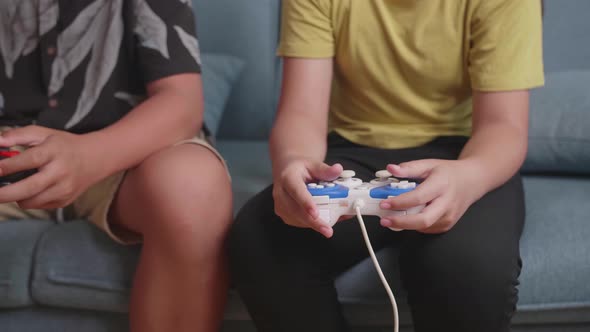 Close Up Children's Hands Holding Joystick Game Play Video Game At Home alt