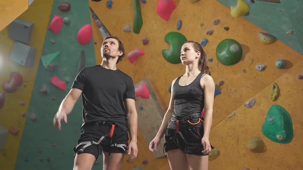 Man and Woman Learning the Art of Rock Climbing at an Indoor Climbing Centre