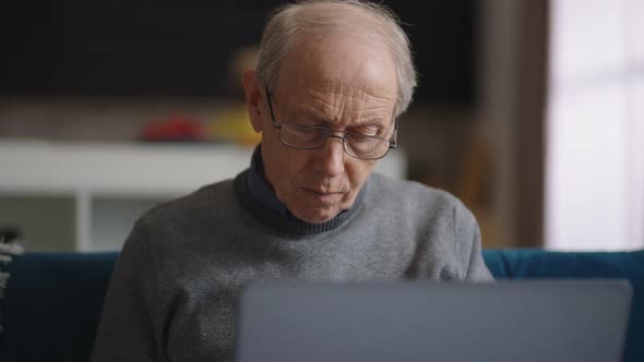 Old Wrinkled and Bald Man is Working in His Home Office Portrait of Male Retiree in Apartment Using alt