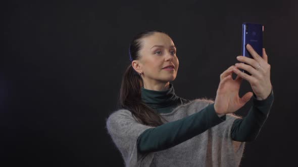 Mature Woman Enjoys New Smartphone Taking Pretty Selfies alt