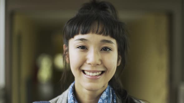 Portrait of smiling teenage girl standing in corridor