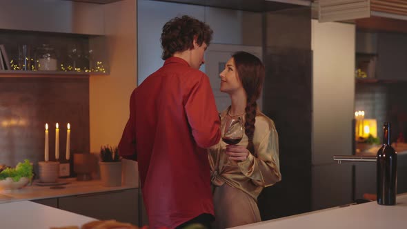 Couple in Love Dancing Ad Drinking Wine While Dating at Home alt