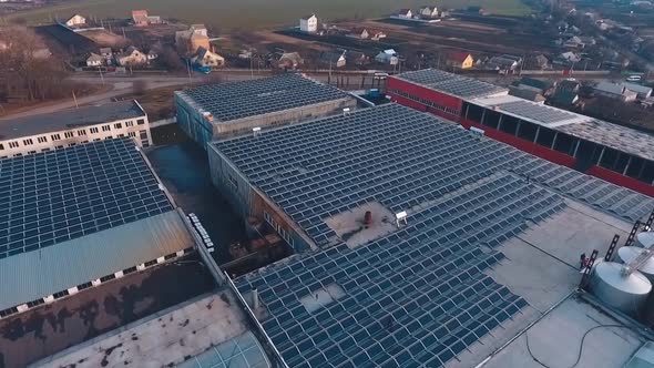 Solar farm on roofs of industrial buildings. alt