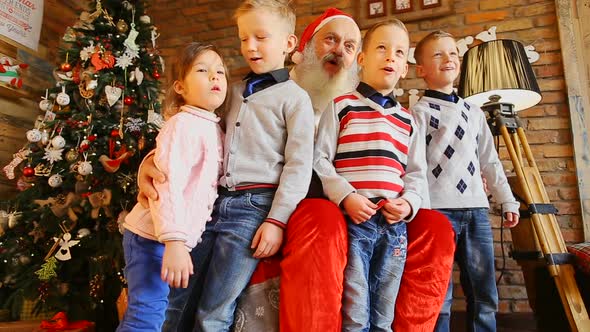 Four Children Sing with Santa.