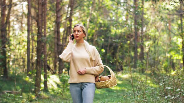 Woman with Mushrooms Calling on Cellphone in Woods alt