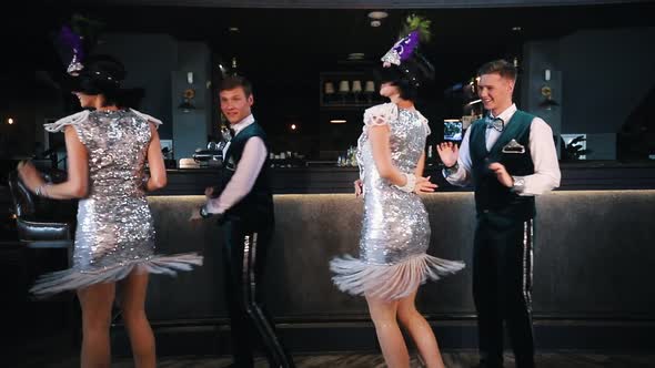 Theme Party - Young Smiling People in Glistening Retro Clothes Dancing alt