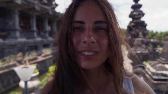 Close Up Portrait of a Tourist Woman Background Bajra Sandhi Monument in Bali. Travel Concept.