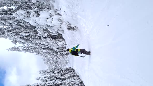 Man Snowboarder Riding By Snowed Slope in Beautiful Mountains alt