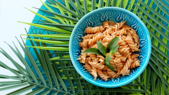 Fusilli Macaroni On Bowl With Green Decoration Leaves Rotating