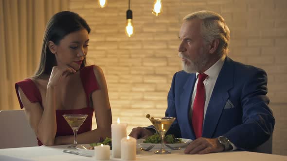 Young Woman Assessing Status of Reach Old Man Nearby, Fake Love, Acquaintance alt