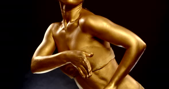 Slim Woman with Golden Skin Is Dancing, Closeup View of Her Body, Body-art alt