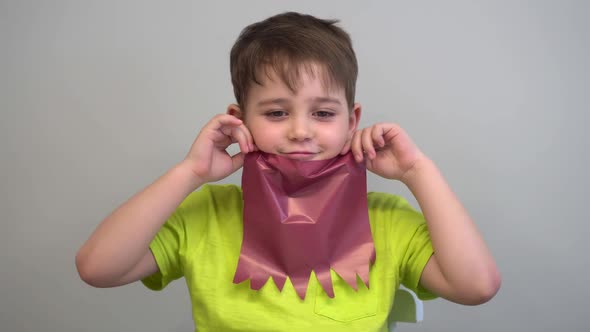 a Boy with a Colored Paper Beard Poses for the Camera
