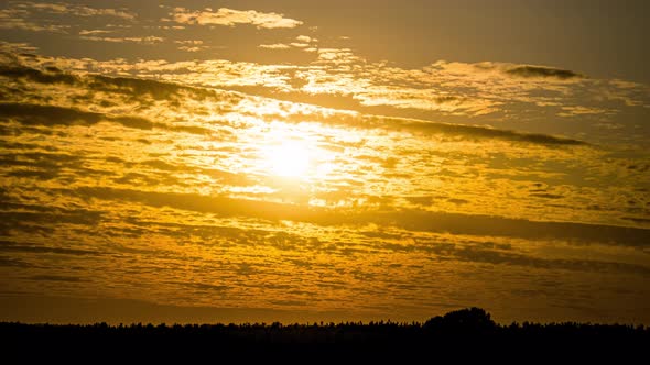 Amazing Dramatic Sunset Behind the Cumulus Cirrus Clouds. Time Lapse. alt