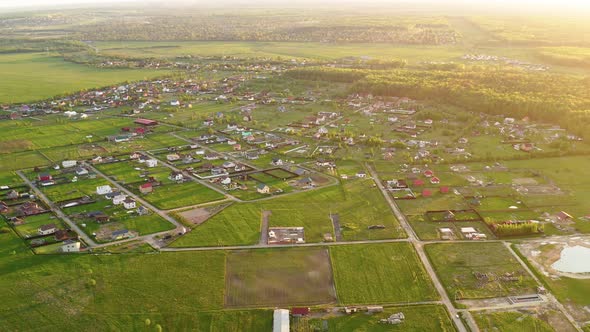 Drone flying above fields and village