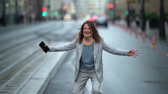 Funny Adult Woman with Neck Brace Is Dancing Jokingly on City Street, Osteochondrosis or Cervical alt