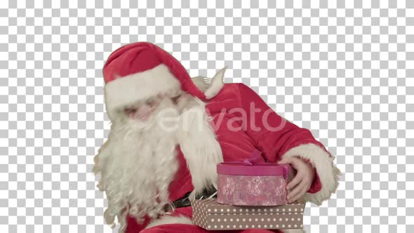 Santa Claus holding a gift in his hand, Alpha Channel