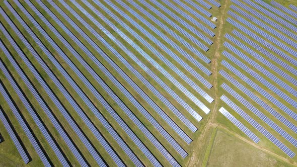 Aerial View of Big Sustainable Electric Power Plant with Many Rows of Solar Photovoltaic Panels for alt