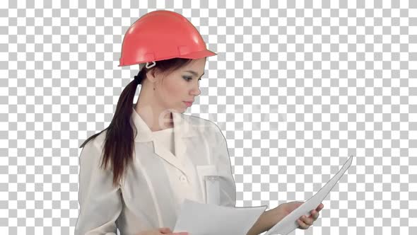 Female engineer in helmet reading contract, Alpha Channel