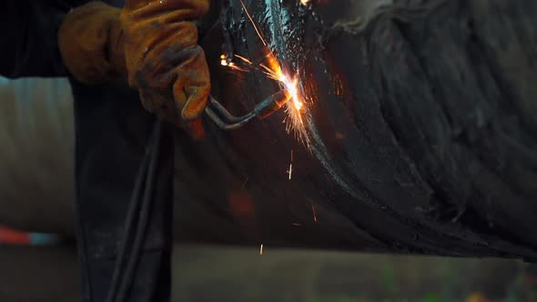 The Welder Cuts a Large Pipe with Acetylene Welding for Gasification