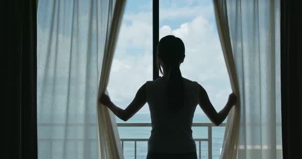 Woman open the curtain alt