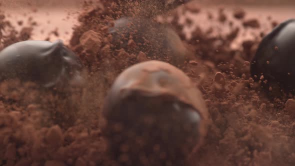 Chocolate truffles falling into chocolate powder in super slow motion.  Shot on Phantom Flex 4K high
