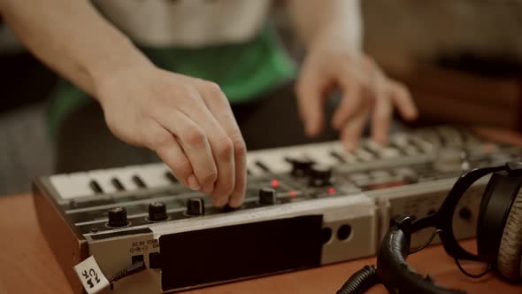 Crop Man Playing Digital Keyboard