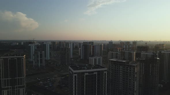 City block construction site. Multi-storey buildings. City landscape at sunrise. Aerial photography. alt