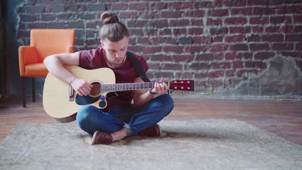 Handsome Young Man Playing Acoustic Guitar Sitting Floor Living Loft Room