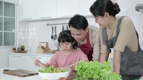 Family cooking in kitchen alt