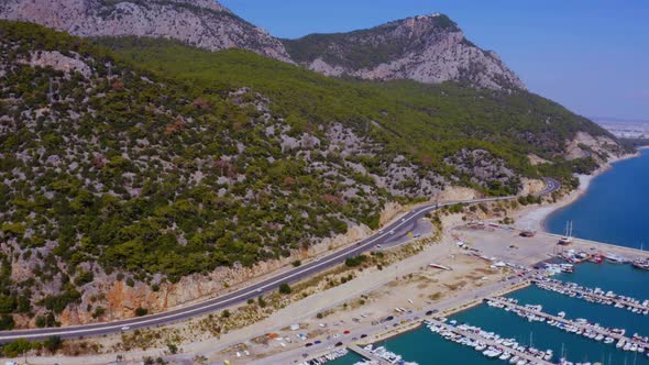 Aerial View of Mountain Road Near the Coastline Sea Port alt