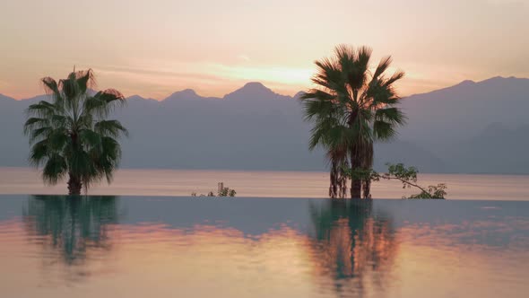 A reflective swimming pool boundary and an evening sea scenery alt