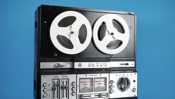 Rotating Old Reel To Reel Tape Recorder On A Blue Background 1.