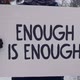 Man is expressing his oppinion on opression with a sign saying Enough Is Enough - VideoHive Item for Sale
