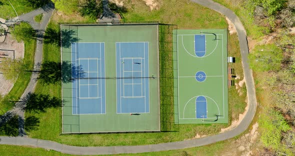 Outdoor Tennis Court and Basketball Field in the Park From a Height in Autumn alt