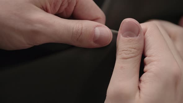 Slow Motion Man Hand Inspectingsoft Leather Jacket with Sun Shining From a Window alt