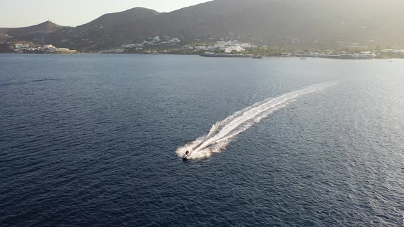 Aerial View of a Jet Ski Boat in a Deep Blue Colored Sea. Spinalonga Island, Crete, Greece