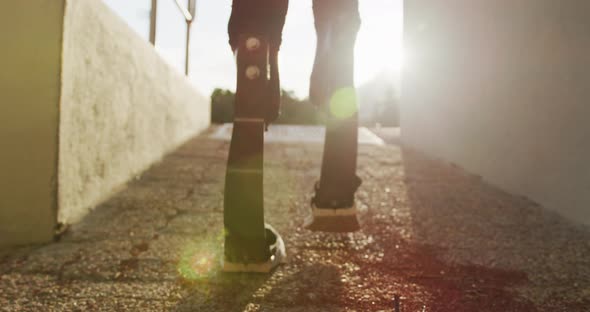 Disabled mixed race man with prosthetic legs walking to the sports stadium alt
