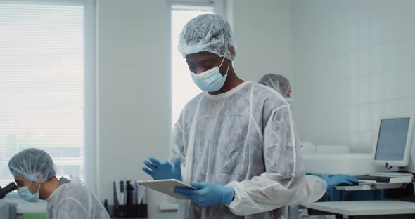 A Team of Laboratory Technicians Work in a Modern Wellequipped Laboratory alt