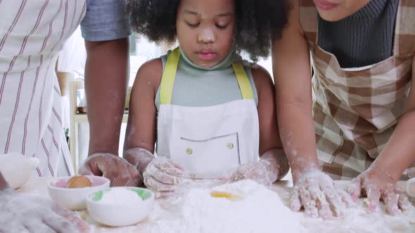Close up of enjoy African American girl thresh dough at home in the kitchen