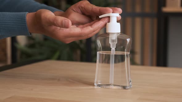 Close-up of Man Using Hand Sanitizer Gel To Prevent Spreading Virus or Bacteria. alt