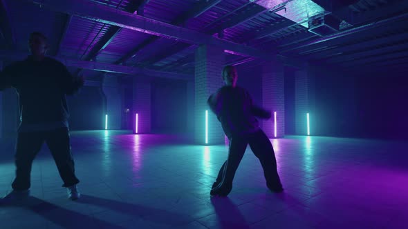 Two Stylish Professional Female and Male Dancers Performing a Hip Hop Dance Routine in Virtual alt