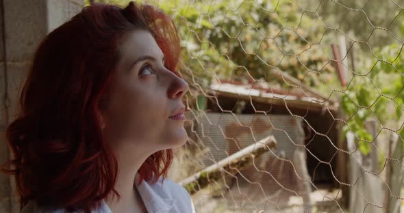 Young female vet checks the chicken coop alt