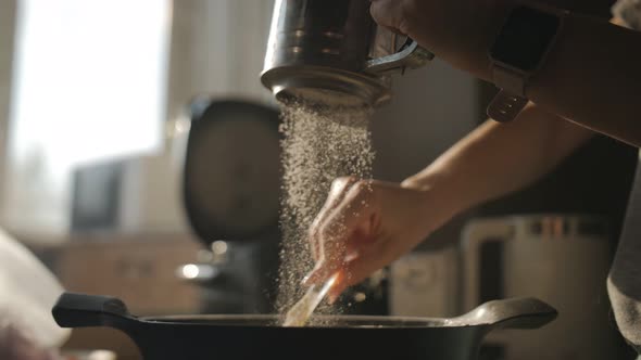 A Woman Prepares Dough for Baking in the Kitchen