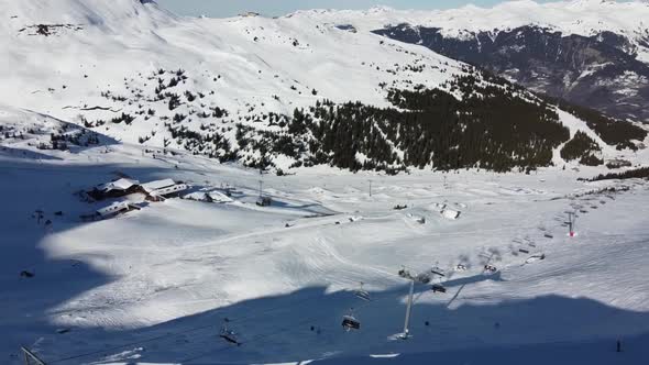 Aerial View of the Alps Mountains in France. Mountain Tops Covered in Snow. Alpine Ski Facilities