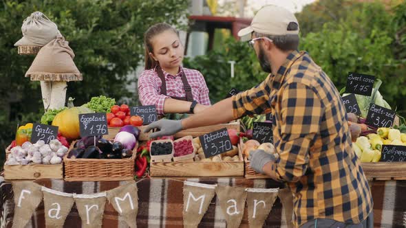Father and Daughter Work at the Farmers Market alt