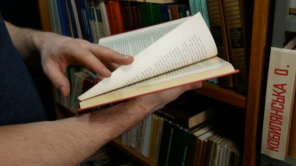 Man Leafing Through A History Book